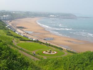 a park next to a beach with the ocean at Hotel Ellenby in Scarborough