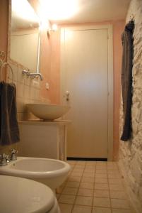a bathroom with a sink and a toilet and a mirror at *Sibun in Ceglie Messapica