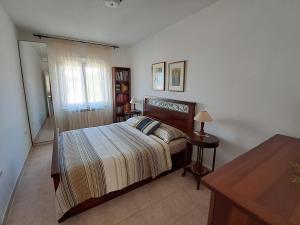a bedroom with a bed and a table and a window at Apartment Complex Kampic in Poreč