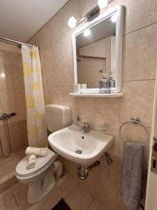 a bathroom with a sink and a toilet and a mirror at Luxury Beach House Perfect For Vacations in Xiropigado +13 photos