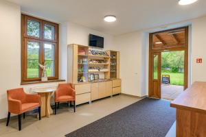 - une cuisine avec des chaises orange et une table dans une chambre dans l'établissement Hotel Nádraží, 