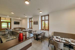 a restaurant with tables and chairs and a bar at Hotel Nádraží 