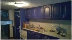 a kitchen with purple cabinets and a sink at Fanis in Paralía Néas Epidhávrou