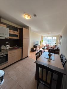 a kitchen and living room with a table and chairs at Paradise View in Sunny Beach