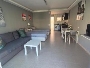 a living room with a couch and a table at Studio in city in Fuengirola