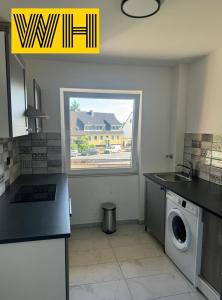 a kitchen with a washing machine and a window at Wohnung mit 4 Betten KÖ1 in Hannover