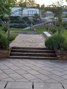 a set of stairs in a garden with grass at Apartamentos O Caneiro in Portomarin