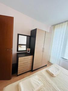 a bedroom with a bed and a dresser and a mirror at Paradise View in Sunny Beach