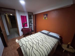 Un pat sau paturi într-o cameră la El Hospedaje del Muki