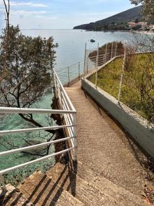 a metal fence next to a body of water at Luxury Beach House Perfect For Vacations in Xiropigado