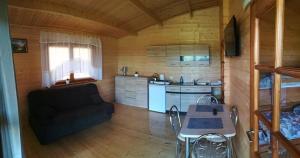 a living room with a couch and a table at Domki na Wzgórzu in Ryn