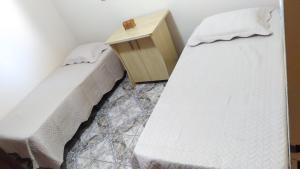 Postelja oz. postelje v sobi nastanitve Casa Confortável na Região da Pampulha