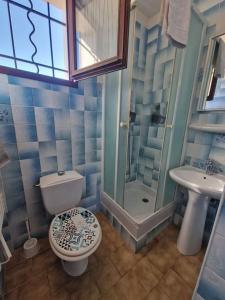 een blauwe badkamer met een toilet en een wastafel bij Agréable Appartement in La Londe-les-Maures