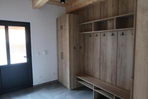 a room with wooden cabinets and a window and a door at Wellness chata Kouty in Loučná nad Desnou