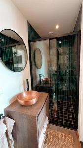 a bathroom with a wooden sink and a shower at Tiny house of Picasso in Warmenhuizen