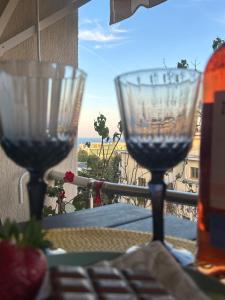 two wine glasses on a table with a view of the ocean at Kolevi Family Seaside Haven! in St. St. Constantine and Helena