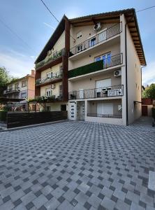 a large apartment building with a parking lot at MP Apartman in Soko Banja