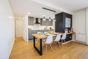 a kitchen and dining room with a table and chairs at Just Like Home - Moledo Waves in Moledo +23 photos