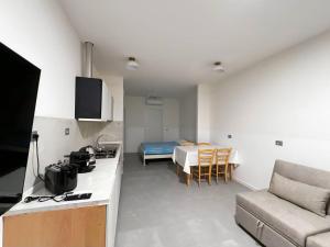 a kitchen and living room with a couch and a bed at Non ti scordar di me #2 in Pieris