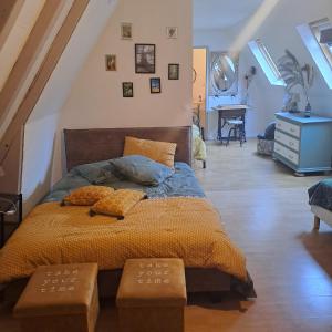 a bedroom with a bed with two pillows on it at Maison de Vacances in Tursac