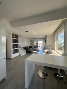 a kitchen and living room with a large white table at Villa Thalia in Kavála