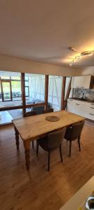 a large wooden table in a kitchen with chairs at Castello Apartment Boppard in Boppard
