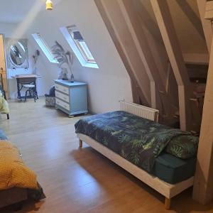 a bedroom with a bed and a dresser with windows at Maison de Vacances in Tursac