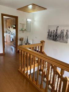 a wooden staircase in a living room with a kitchen at Alojamiento Finca La Campa 