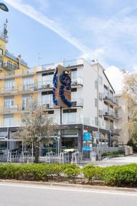 a large apartment building with a large sign on it at Residence Rex in Chioggia