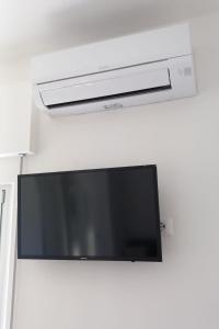 a flat screen tv hanging on a wall at Casa Luce in Marina di Massa +34 photos