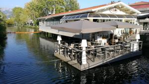 a restaurant with umbrellas on a boat on a river at Casa Luce in Marina di Massa