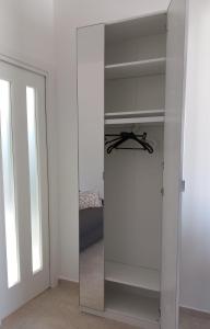 a glass closet with a mirror in a room at Casa Luce in Marina di Massa