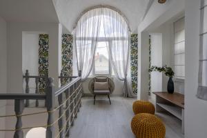 a living room with a staircase and a window at Kosmajski Izvor in Sopot