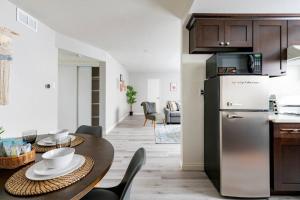 a kitchen and dining room with a table and a refrigerator at Explore DT Alhambra in Alhambra