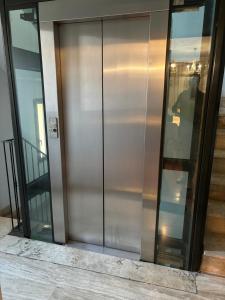 a large glass door of a building at Michelangelo Apartment Pescara in Pescara