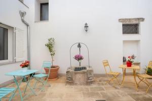 a patio with chairs and a table and a fireplace at Casa Vacanze LuLiVi in Giuggianello