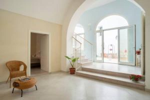 a living room with a chair and a large window at Casa Vacanze LuLiVi in Giuggianello