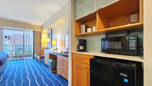 a hotel room with a kitchen with a microwave at Ala Moana Hotel _ Ocean view with balcony in Honolulu