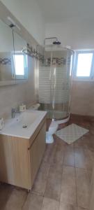 a bathroom with a sink and a toilet in it at Casa di Calma in Ermoupoli +21 photos