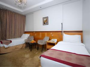 a hotel room with two beds and a desk at Nasamaat Ajyad Hotel in Mecca +62 photos