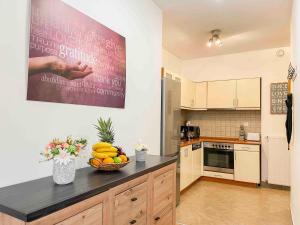 a kitchen with a bowl of fruit on a counter at Opera Residence in Budapest