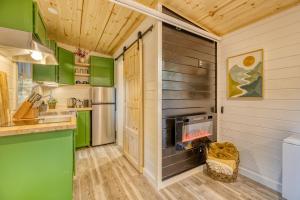 a kitchen with green and wooden walls and a fireplace at Couples Retreat: King Bed:Hot tub:Firepit & More in Blue Ridge