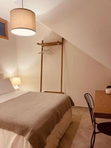 a bedroom with a bed and a table with a chair at SEAFRONT Pantokratoras #Preveza in Preveza +13 photos