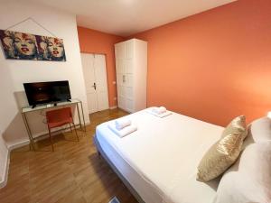 una piccola stanza con un letto e una televisione di Nuovo appartamento Saint Remy a Cagliari