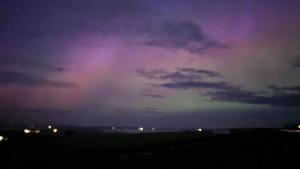 a stormy sky at night with a purple at Glengolly Getaways in Thurso