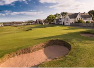 a golf course with a hole in the grass at Wellington Retreat in Montrose