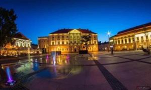 a group of buildings in a square at night at Rooms Spanie 7-Rynek Centrum &f-vat in Kielce