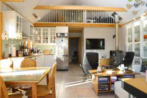 a kitchen and living room with a table and chairs at Charming Cabin close to Akureyri in Halllandsnes