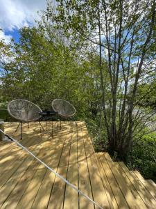 a table and chairs on a wooden deck at Glamping Tent Mariehamn in Mariehamn