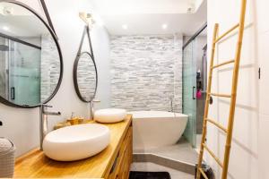 a bathroom with a white tub and a sink at Maison des voyageurs rosier - PARIS ORLY in Choisy-le-Roi +8 photos